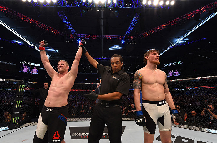 MELBOURNE, AUSTRALIA - NOVEMBER 15: Referee Herb Dean (C) announces Daniel Kelly (L) winner by unanimous decision against Steve Montgomery (R) after their middleweight bout during the UFC 193 event at Etihad Stadium on November 15, 2015 in Melbourne, Aus