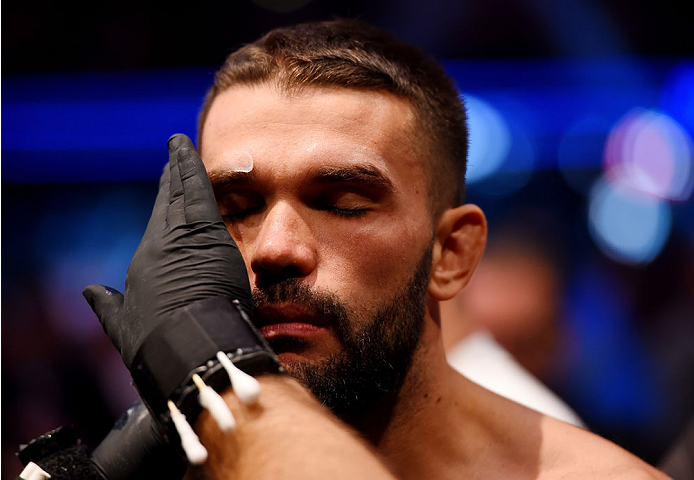 MELBOURNE, AUSTRALIA - NOVEMBER 15: Peter Sobotta meets with the cut man before fighting against Kyle Noke (not pictured) in their welterweight bout during the UFC 193 event at Etihad Stadium on November 15, 2015 in Melbourne, Australia. (Photo by Josh