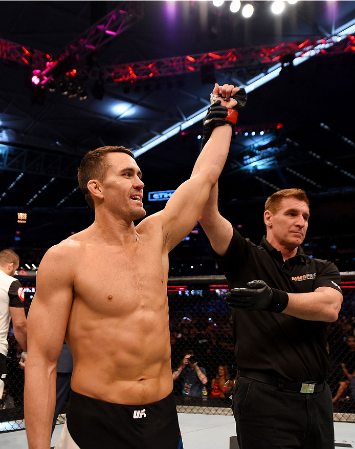 MELBOURNE, AUSTRALIA - NOVEMBER 15: Referee Steve Perceval (C) announces Kyle Noke (L) winner by TKO (body kick and punches) against Peter Sobotta (not pictured) in their welterweight bout during the UFC 193 event at Etihad Stadium on November 15, 2015 i
