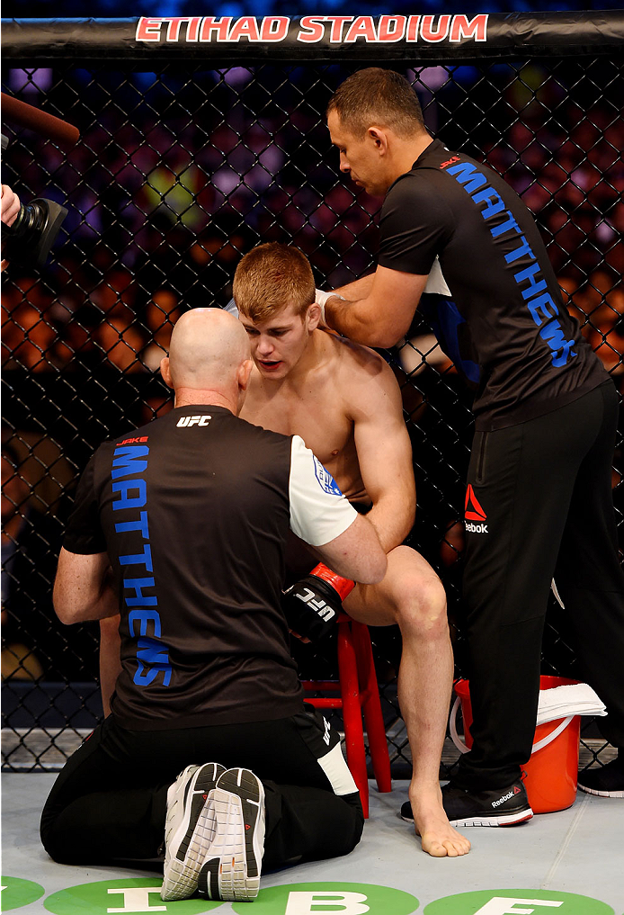 MELBOURNE, AUSTRALIA - NOVEMBER 15: Jake Matthews talks with his corner men during a break between rounds during his lightweight bout against Akbarh Arreola (not pictured) during the UFC 193 event at Etihad Stadium on November 15, 2015 in Melbourne, Austr
