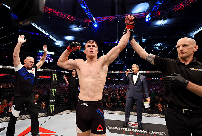 MELBOURNE, AUSTRALIA - NOVEMBER 15: Referee Greg Kleynjans announces Jake Matthews (L) winner by TKO (doctor stoppage) over Akbarh Arreola (not pictured) after their lightweight bout during the UFC 193 event at Etihad Stadium on November 15, 2015 in Melb