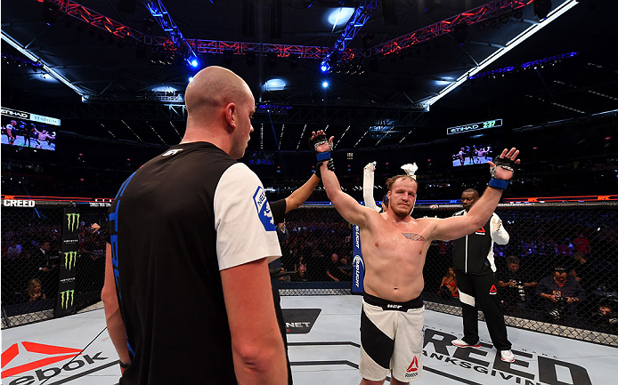 MELBOURNE, AUSTRALIA - NOVEMBER 15: Referee Herb Dean (C) announces Jared Rosholt (R) winner by Unanimous Decision over Stefan Struve (L) in their heavyweight bout during the UFC 193 event at Etihad Stadium on November 15, 2015 in Melbourne, Australia.
