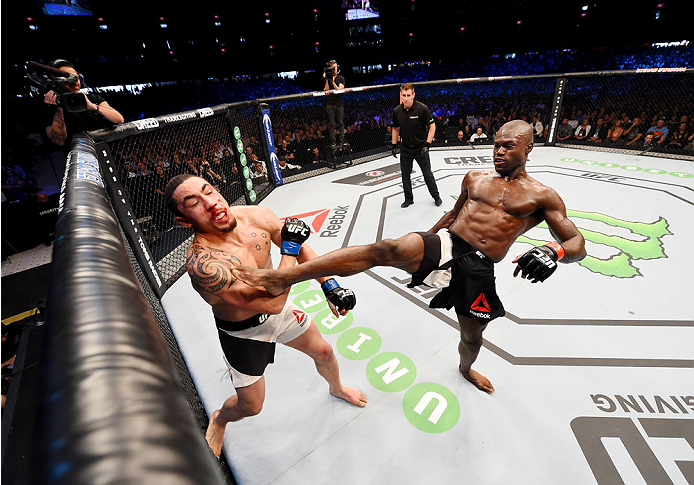 MELBOURNE, AUSTRALIA - NOVEMBER 15: Uriah Hall (R) throws a front kick to the face of Robert Whittaker (L) in their middleweight bout during the UFC 193 event at Etihad Stadium on November 15, 2015 in Melbourne, Australia. (Photo by Josh Hedges/Zuffa LL