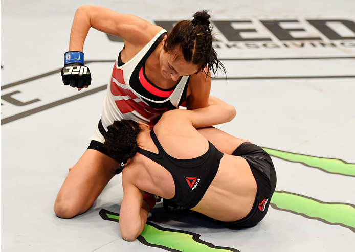 MELBOURNE, AUSTRALIA - NOVEMBER 15: Valerie Letourneau works from the top as she punches Joanna Jedrzejczyk (B) in their UFC women's strawweight championship bout during the UFC 193 event at Etihad Stadium on November 15, 2015 in Melbourne, Australia. (P