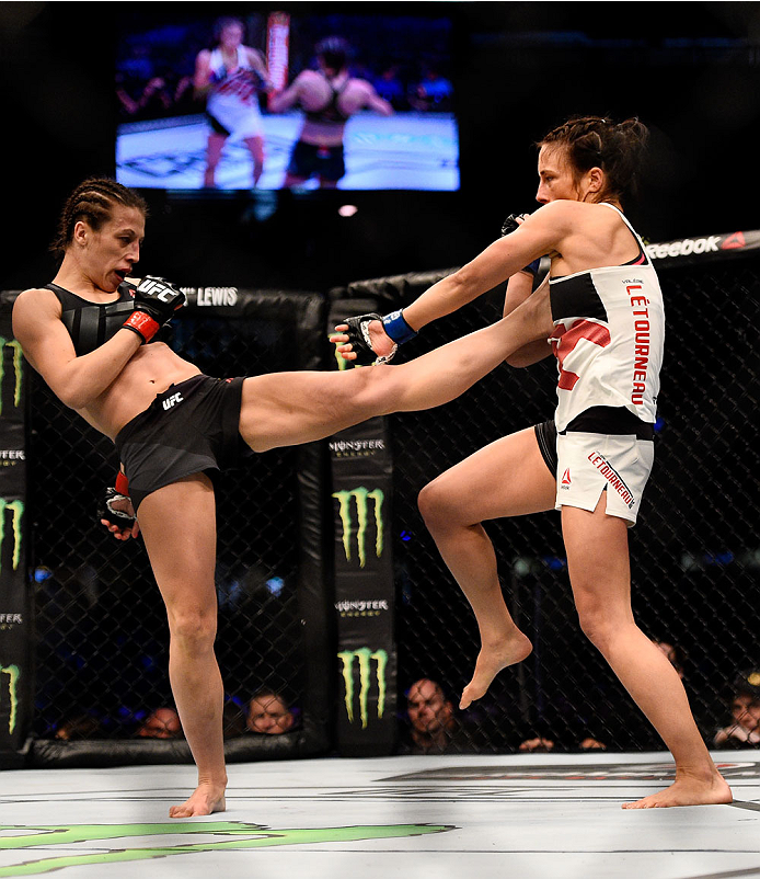 MELBOURNE, AUSTRALIA - NOVEMBER 15: Joanna Jedrzejczyk (L) kicks against Valerie Letourneau (R) in their UFC women's strawweight championship bout during the UFC 193 event at Etihad Stadium on November 15, 2015 in Melbourne, Australia. (Photo by Jeff Bo