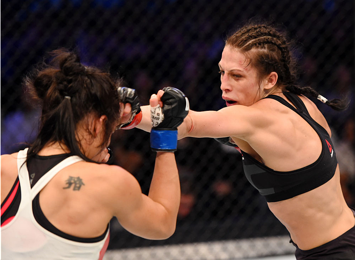 MELBOURNE, AUSTRALIA - NOVEMBER 15: Joanna Jedrzejczyk (R) throws a punch against Valerie Letourneau (L) in their UFC women's strawweight championship bout during the UFC 193 event at Etihad Stadium on November 15, 2015 in Melbourne, Australia. (Photo b
