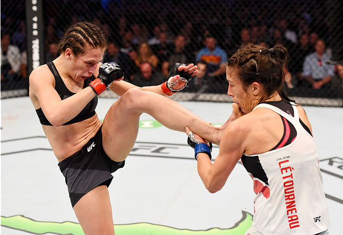 MELBOURNE, AUSTRALIA - NOVEMBER 15: (L-R) Joanna Jedrzejczyk kicks Valerie Letourneau in their UFC women's strawweight championship bout during the UFC 193 event at Etihad Stadium on November 15, 2015 in Melbourne, Australia. (Photo by Josh Hedges/Zuffa