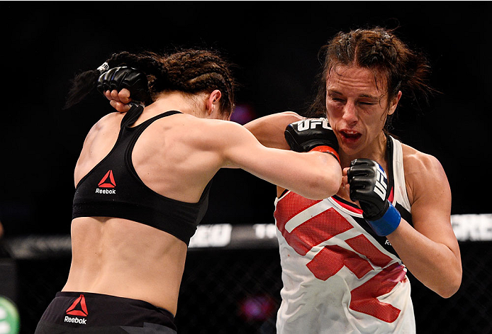MELBOURNE, AUSTRALIA - NOVEMBER 15: (L-R) Joanna Jedrzejczyk and Valerie Letourneau exchange punches in their UFC women's strawweight championship bout during the UFC 193 event at Etihad Stadium on November 15, 2015 in Melbourne, Australia. (Photo by Je