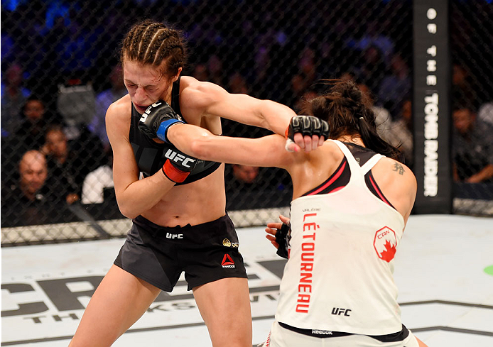 MELBOURNE, AUSTRALIA - NOVEMBER 15: (L-R) Joanna Jedrzejczyk and Valerie Letourneau exchange punches in their UFC women's strawweight championship bout during the UFC 193 event at Etihad Stadium on November 15, 2015 in Melbourne, Australia. (Photo by Jos