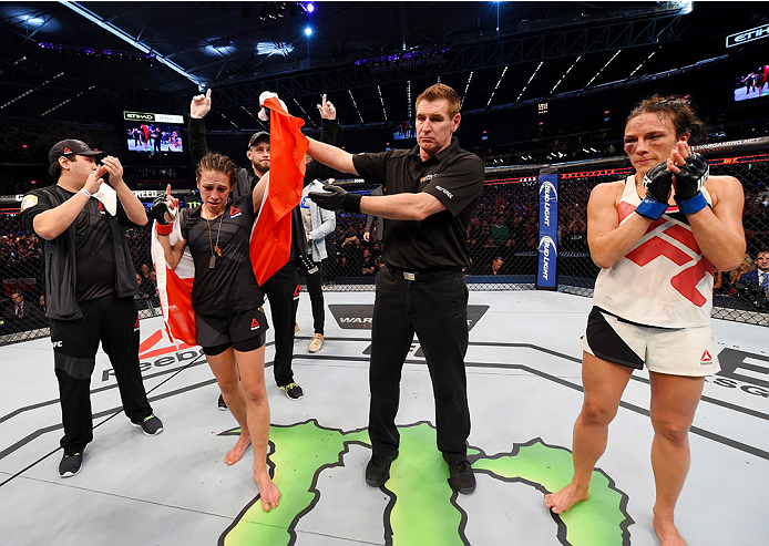 MELBOURNE, AUSTRALIA - NOVEMBER 15: Referee Steve Perceval (C) announces Joanna Jedrzejczyk (L) winner by Unanimous Decision after five rounds against Valerie Letourneau (R) in their UFC women's strawweight championship bout during the UFC 193 event at E