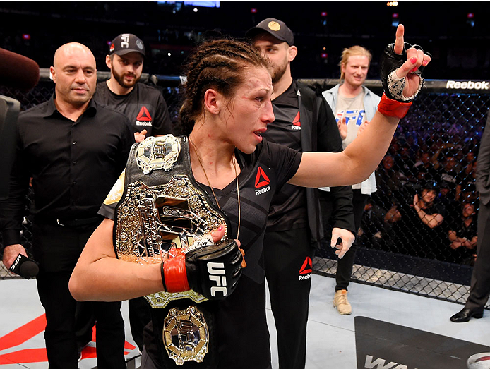 MELBOURNE, AUSTRALIA - NOVEMBER 15: Joanna Jedrzejczyk celebrates her championship win by Unanimous Decision after five rounds against Valerie Letourneau (not pictured) in their UFC women's strawweight championship bout during the UFC 193 event at Etihad