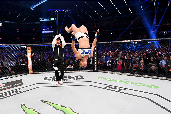 MELBOURNE, AUSTRALIA - NOVEMBER 15: Holly Holm does a back-flip in celebrateion of her second round KO (head kick and punches) over Ronda Rousey (not pictured) to win their UFC women's bantamweight championship bout during the UFC 193 event at Etihad Sta
