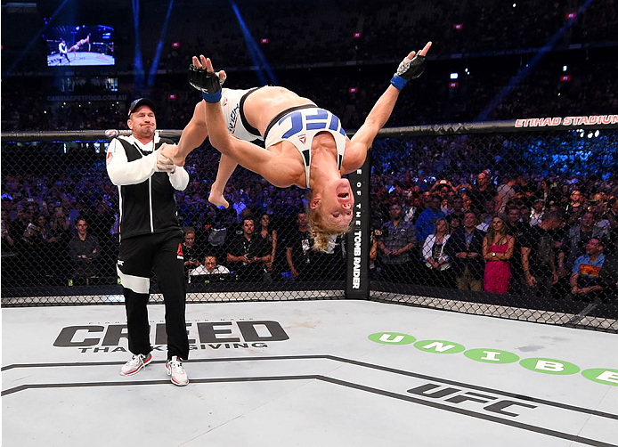 MELBOURNE, AUSTRALIA - NOVEMBER 15: Holly Holm does a back-flip in celebrateion of her second round KO (head kick and punches) over Ronda Rousey (not pictured) to win their UFC women's bantamweight championship bout during the UFC 193 event at Etihad Sta