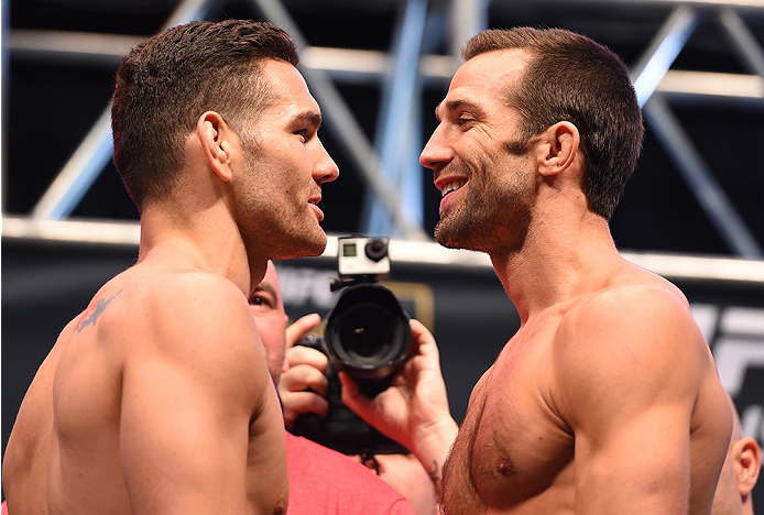 LAS VEGAS, NV - DECEMBER 11: (L-R) UFC middleweight champion Chris Weidman and challenger Luke Rockhold face off during the UFC 194 weigh-in inside MGM Grand Garden Arena on December 10, 2015 in Las Vegas, Nevada. (Photo by Josh Hedges/Zuffa LLC/Zuffa