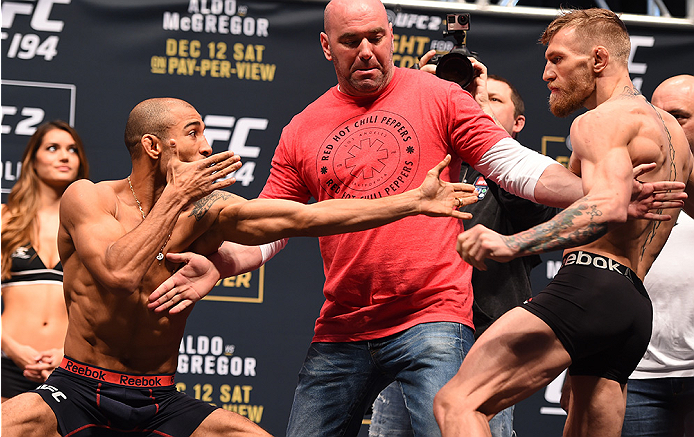 LAS VEGAS, NV - DECEMBER 11: (L-R) UFC featherweight champion Jose Aldo of Brazil and interim UFC featherweight champion Conor McGregor of Ireland face off during the UFC 194 weigh-in inside MGM Grand Garden Arena on December 10, 2015 in Las Vegas, Nevad