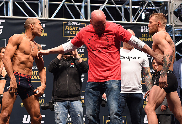 LAS VEGAS, NV - DECEMBER 11: (L-R) UFC featherweight champion Jose Aldo of Brazil and interim UFC featherweight champion Conor McGregor of Ireland face off during the UFC 194 weigh-in inside MGM Grand Garden Arena on December 10, 2015 in Las Vegas, Nevad