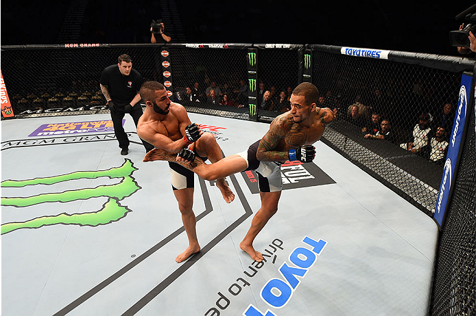 LAS VEGAS, NV - DECEMBER 12: (R-L) Yancy Medeiros kicks John Makedssi of Canada in their lightweight bout during the UFC 194 event inside MGM Grand Garden Arena on December 12, 2015 in Las Vegas, Nevada. (Photo by Josh Hedges/Zuffa LLC/Zuffa LLC via Gett