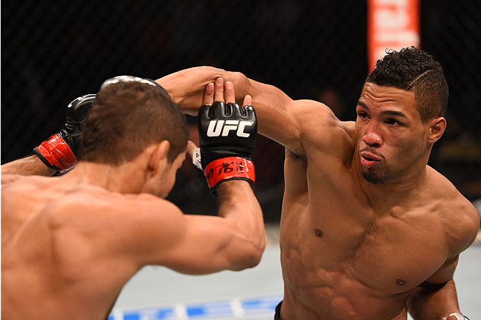 LAS VEGAS, NV - DECEMBER 12: (R-L) Kevin Lee punches Leonardo Santos of Brazil in their lightweight bout during the UFC 194 event inside MGM Grand Garden Arena on December 12, 2015 in Las Vegas, Nevada. (Photo by Josh Hedges/Zuffa LLC/Zuffa LLC via Getty
