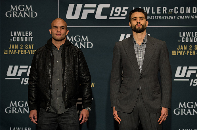 LAS VEGAS, NEVADA - DECEMBER 31: (L-R) UFC welterweight champion Robbie Lawler and Carlos Condit pose for a picture after facing off during the Ultimate Media Day at the MGM Grand Hotel/Casino on December 31, 2015 in Las Vegas Nevada. (Photo by Brandon M