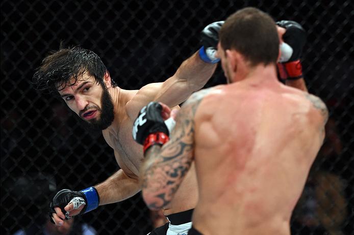 CURITIBA, BRAZIL - MAY 14: (L-R) Zubaira Tukhugov of Russia punches Renato Moicano of Brazil in their featherweight bout during the UFC 198 event at Arena da Baixada stadium on May 14, 2016 in Curitiba, Parana, Brazil. (Photo by Josh Hedges/Zuffa LLC/Zu