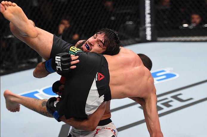 CURITIBA, BRAZIL - MAY 14: (L-R) Zubaira Tukhugov of Russia takes down Renato Moicano of Brazil in their featherweight bout during the UFC 198 event at Arena da Baixada stadium on May 14, 2016 in Curitiba, Parana, Brazil. (Photo by Josh Hedges/Zuffa LLC