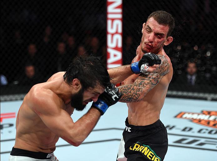 CURITIBA, BRAZIL - MAY 14: (L-R) Zubaira Tukhugov of Russia punches Renato Moicano of Brazil in their featherweight bout during the UFC 198 event at Arena da Baixada stadium on May 14, 2016 in Curitiba, Parana, Brazil. (Photo by Josh Hedges/Zuffa LLC/Zu