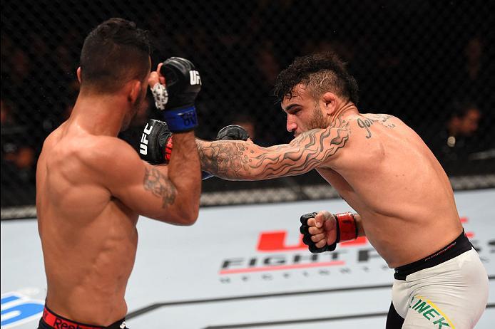 CURITIBA, BRAZIL - MAY 14: (R-L) John Lineker of Brazil punches Rob Font in their bantamweight bout during the UFC 198 event at Arena da Baixada stadium on May 14, 2016 in Curitiba, Parana, Brazil. (Photo by Josh Hedges/Zuffa LLC/Zuffa LLC via Getty Ima