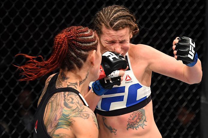 CURITIBA, BRAZIL - MAY 14: (L-R) Cristiane 'Cyborg' Justino of Brazil punches Leslie Smith in their women's catchweight bout during the UFC 198 event at Arena da Baixada stadium on May 14, 2016 in Curitiba, Parana, Brazil. (Photo by Josh Hedges/Zuffa LL