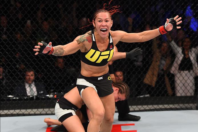CURITIBA, BRAZIL - MAY 14: (L-R) Cristiane 'Cyborg' Justino of Brazil celebrates after defeating Leslie Smith in their women's catchweight bout during the UFC 198 event at Arena da Baixada stadium on May 14, 2016 in Curitiba, Parana, Brazil. (Photo by J