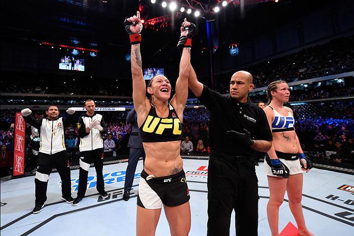 CURITIBA, BRAZIL - MAY 14: (L-R) Cristiane 'Cyborg' Justino of Brazil celebrates after defeating Leslie Smith in their women's catchweight bout during the UFC 198 event at Arena da Baixada stadium on May 14, 2016 in Curitiba, Parana, Brazil. (Photo by J