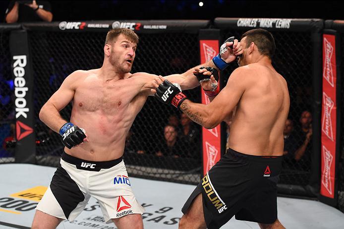 CURITIBA, BRAZIL - MAY 14: (L-R) Stipe Miocic punches Fabricio Werdum of Brazil in their UFC heavyweight championship bout during the UFC 198 event at Arena da Baixada stadium on May 14, 2016 in Curitiba, Parana, Brazil. (Photo by Josh Hedges/Zuffa LLC/