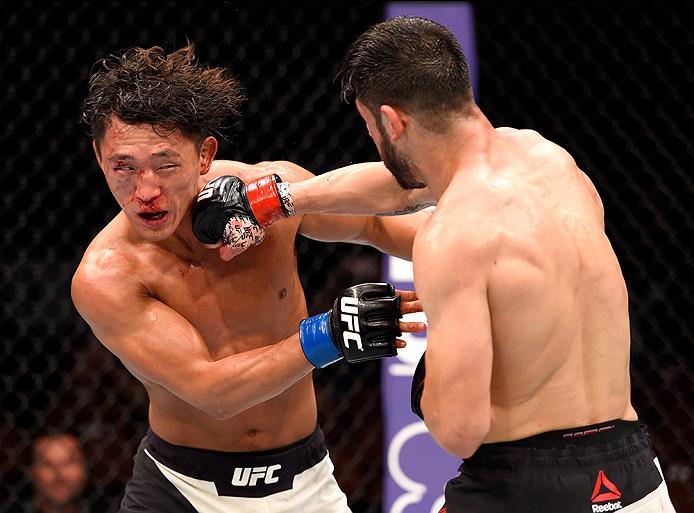 INGLEWOOD, CA - JUNE 04: Polo Reyes of Mexico punches Dong Hyun Kim of South Korea in their lightweight bout during the UFC 199 event at The Forum on June 4, 2016 in Inglewood, California. (Photo by Josh Hedges/Zuffa LLC/Zuffa LLC via Getty Images)