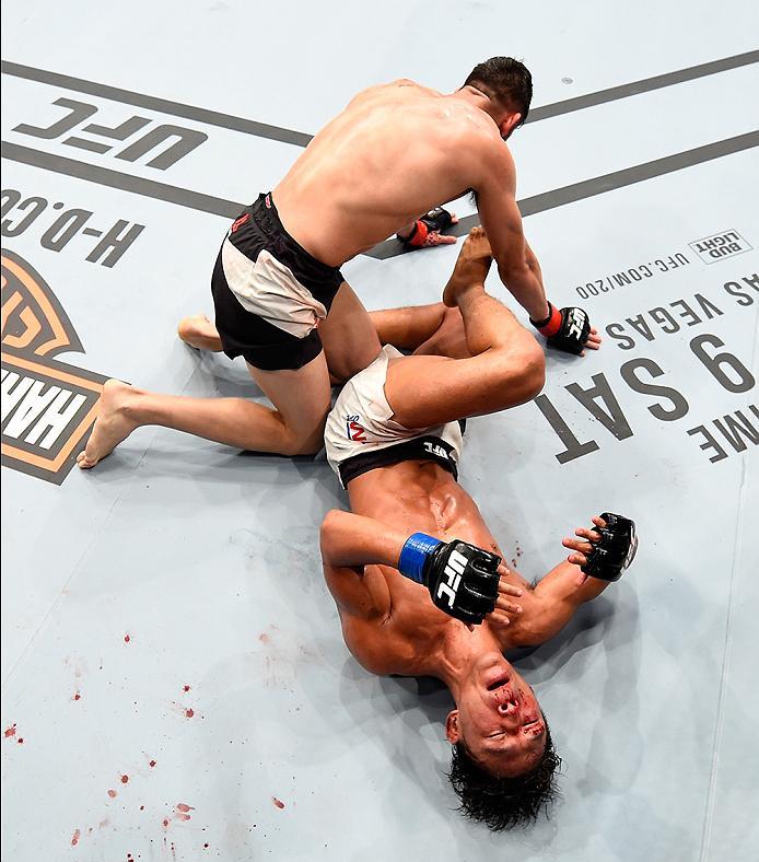INGLEWOOD, CA - JUNE 04: Polo Reyes of Mexico wrestles Dong Hyun Kim of South Korea in their lightweight bout during the UFC 199 event at The Forum on June 4, 2016 in Inglewood, California. (Photo by Josh Hedges/Zuffa LLC/Zuffa LLC via Getty Images)