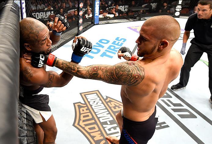 INGLEWOOD, CA - JUNE 04: Dustin Poirier punches Bobby Green in their lightweight bout during the UFC 199 event at The Forum on June 4, 2016 in Inglewood, California. (Photo by Josh Hedges/Zuffa LLC/Zuffa LLC via Getty Images)