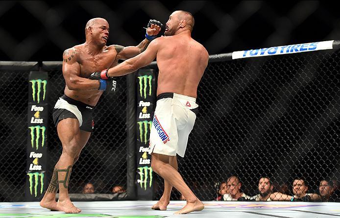 INGLEWOOD, CA - JUNE 04: Hector Lombard of Cuba punches Dan Henderson in their middleweight bout during the UFC 199 event at The Forum on June 4, 2016 in Inglewood, California. (Photo by Harry How/Zuffa LLC/Zuffa LLC via Getty Images)