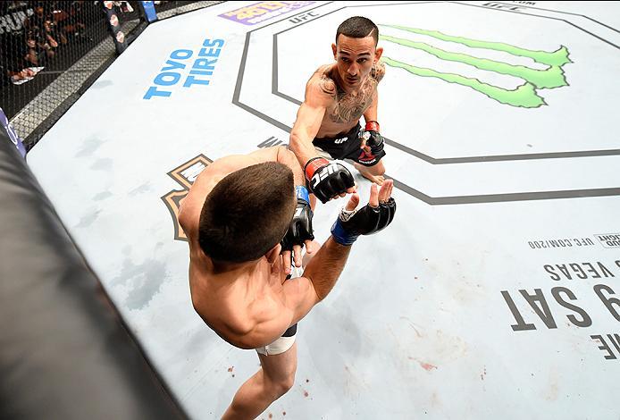 INGLEWOOD, CA - JUNE 04: Max Holloway punches Ricardo Lamas in their featherweight bout during the UFC 199 event at The Forum on June 4, 2016 in Inglewood, California. (Photo by Josh Hedges/Zuffa LLC/Zuffa LLC via Getty Images)