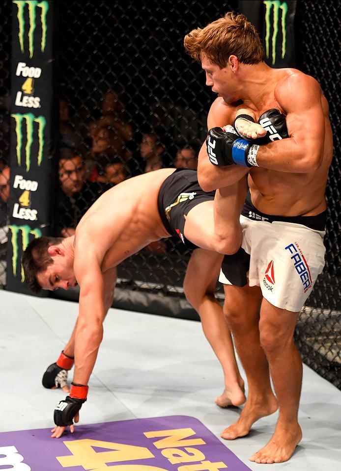 INGLEWOOD, CA - JUNE 04: Urijah Faber holds Dominick Cruz in their UFC bantamweight championship bout during the UFC 199 event at The Forum on June 4, 2016 in Inglewood, California. (Photo by Josh Hedges/Zuffa LLC/Zuffa LLC via Getty Images)