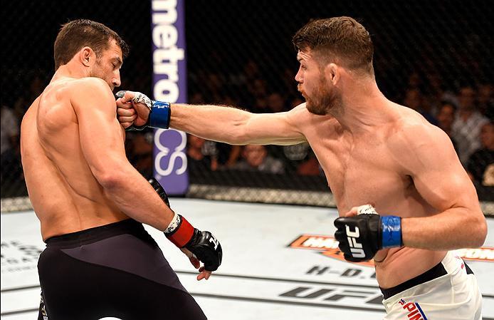 INGLEWOOD, CA - JUNE 04: Michael Bisping of England punches Luke Rockhold in their UFC middleweight championship bout during the UFC 199 event at The Forum on June 4, 2016 in Inglewood, California. (Photo by Josh Hedges/Zuffa LLC/Zuffa LLC via Getty Ima