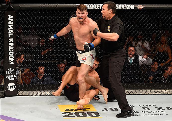INGLEWOOD, CA - JUNE 04: Michael Bisping of England wins in a first round knockout against Luke Rockhold in their UFC middleweight championship bout during the UFC 199 event at The Forum on June 4, 2016 in Inglewood, California. (Photo by Josh Hedges/Zuf
