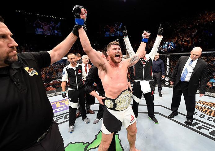 INGLEWOOD, CA - JUNE 04: Michael Bisping of England celebrates after his first round knockout win against Luke Rockhold in their UFC middleweight championship bout during the UFC 199 event at The Forum on June 4, 2016 in Inglewood, California. (Photo by