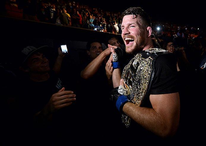 INGLEWOOD, CA - JUNE 04: Michael Bisping of England celebrates with his title belt after his first round knockout win against Luke Rockhold during the UFC 199 event at The Forum on June 4, 2016 in Inglewood, California. (Photo by Brandon Magnus/Zuffa LL