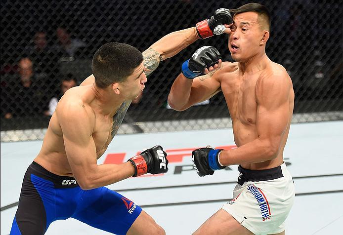 LAS VEGAS, NV - MARCH 04: (L-R) Albert Morales punches Andre Soukhamthath in their bantamweight bout during the UFC 209 event at T-Mobile Arena on March 4, 2017 in Las Vegas, Nevada. (Photo by Josh Hedges/Zuffa LLC/Zuffa LLC via Getty Images) *** Local C