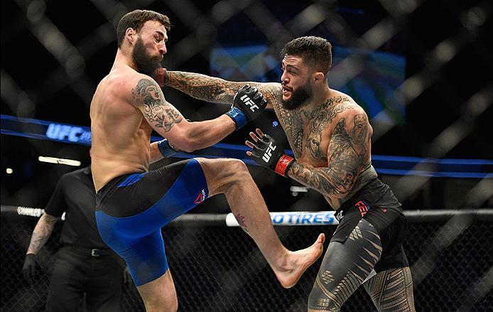 LAS VEGAS, NV - MARCH 04: (R-L) Tyson Pedro of Australia punches Paul Craig of Scotland in their light heavyweight bout during the UFC 209 event at T-Mobile Arena on March 4, 2017 in Las Vegas, Nevada. (Photo by Jeff Bottari/Zuffa LLC/Zuffa LLC via Getty