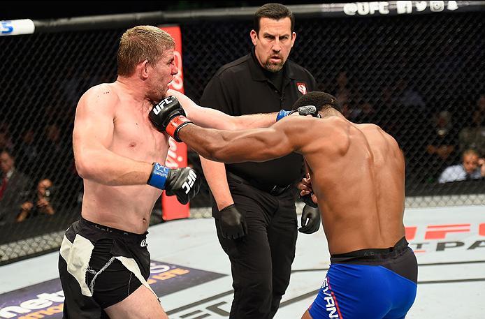 LAS VEGAS, NV - MARCH 04: (L-R) Daniel Kelly of Australia punches Rashad Evans in their middleweight bout during the UFC 209 event at T-Mobile Arena on March 4, 2017 in Las Vegas, Nevada. (Photo by Josh Hedges/Zuffa LLC/Zuffa LLC via Getty Images) *** Lo