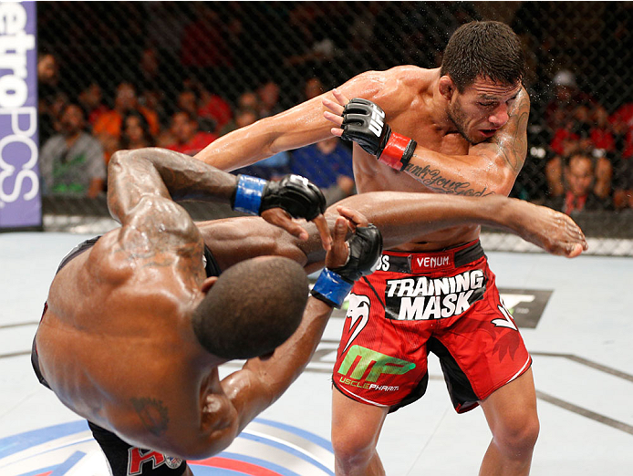 ALBUQUERQUE, NM - JUNE 07: (L-R) Jason High kicks Rafael Dos Anjos in their lightweight fight during the UFC Fight Night event at Tingley Coliseum on June 7, 2014 in Albuquerque, New Mexico. (Photo by Josh Hedges/Zuffa LLC/Zuffa LLC via Getty Images)