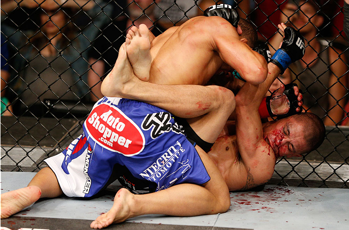 ALBUQUERQUE, NM - JUNE 07: (L-R) John Dodson elbows John Moraga in their flyweight fight during the UFC Fight Night event at Tingley Coliseum on June 7, 2014 in Albuquerque, New Mexico. (Photo by Josh Hedges/Zuffa LLC/Zuffa LLC via Getty Images)