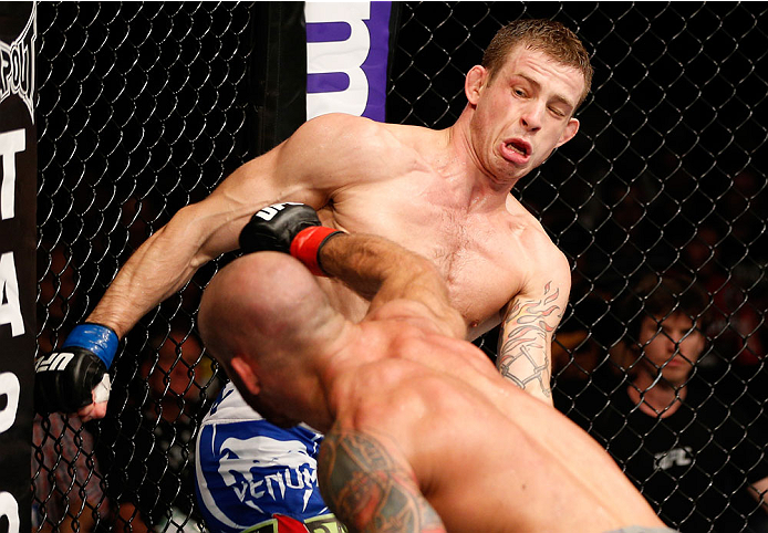 BRISBANE, AUSTRALIA - DECEMBER 07: (L-R) Bruno Santos punches Krzysztof Jotko in their middleweight fight during the UFC Fight Night event at the Brisbane Entertainment Centre on December 7, 2013 in Brisbane, Australia. (Photo by Josh Hedges/Zuffa LLC/Zu