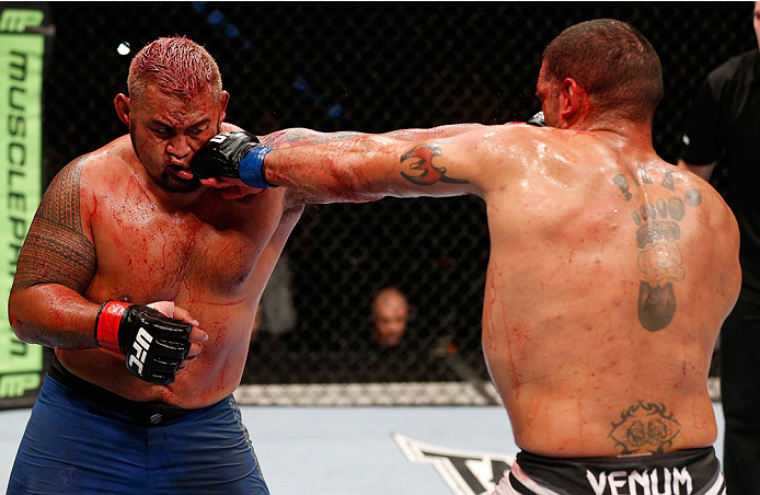 BRISBANE, AUSTRALIA - DECEMBER 07: (R-L) Antonio "Bigfoot" Silva and Mark Hunt trade punches in their heavyweight fight during the UFC Fight Night event at the Brisbane Entertainment Centre on December 7, 2013 in Brisbane, Australia. (Photo by Josh Hedge