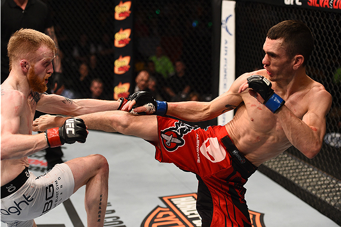 BOSTON, MA - JANUARY 18: (R-L) Shane Howell kicks Paddy Holohan in their flyweight fight during the UFC Fight Night event at the TD Garden on January 18, 2015 in Boston, Massachusetts. (Photo by Jeff Bottari/Zuffa LLC/Zuffa LLC via Getty Images)