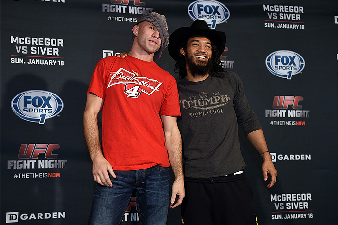BOSTON, MA - JANUARY 16: UFC lightweights Donald 'Cowboy' Cerrone (L) and Benson 'Smooth' Henderson trade hats as they interact with media at Faneuil Hall on January 16, 2015 in Boston, Massachusetts. (Photo by Jeff Bottari/Zuffa LLC/Zuffa LLC via Getty